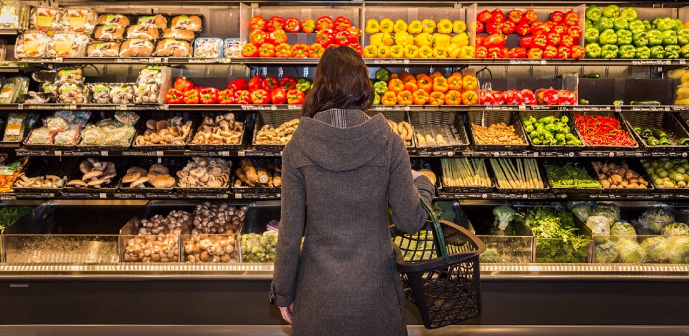 woman at the vegetable aisle in a grocery