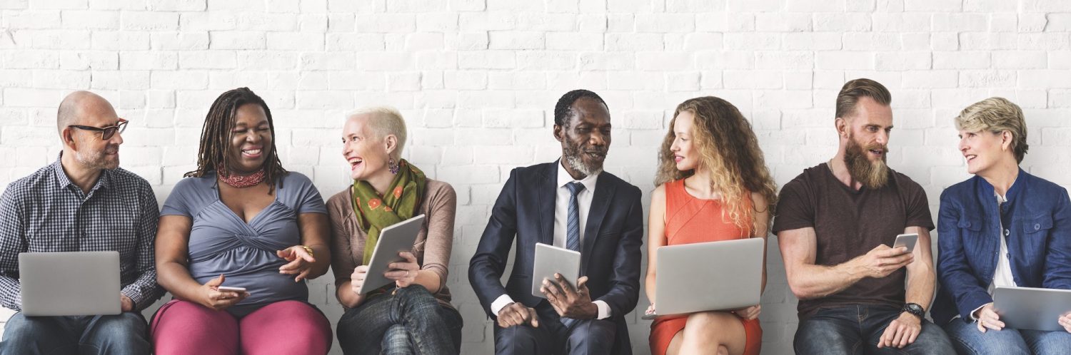 diverse group of people using devices