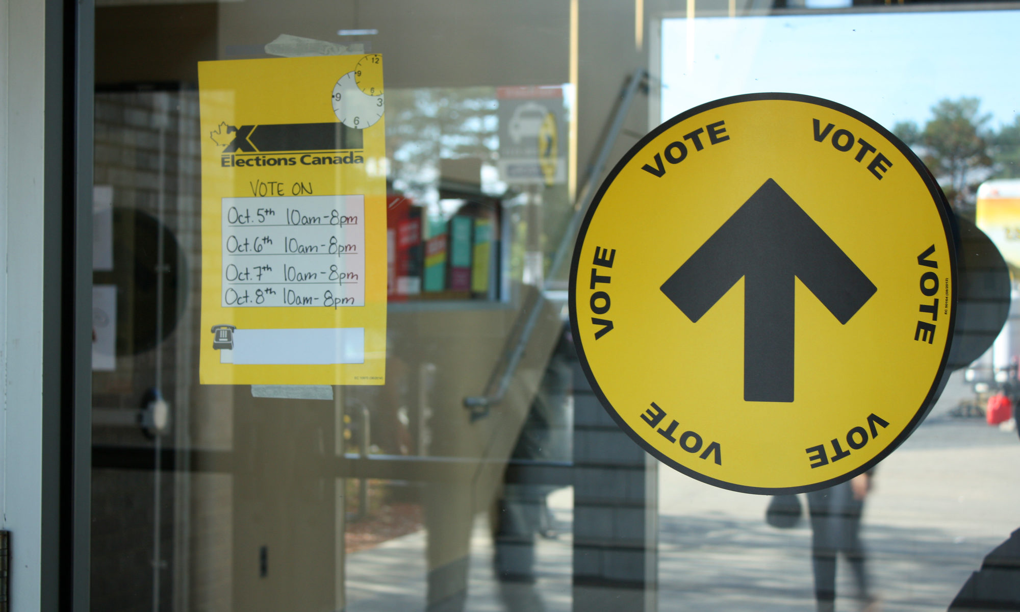 Election signs on a door heading into a polling booth