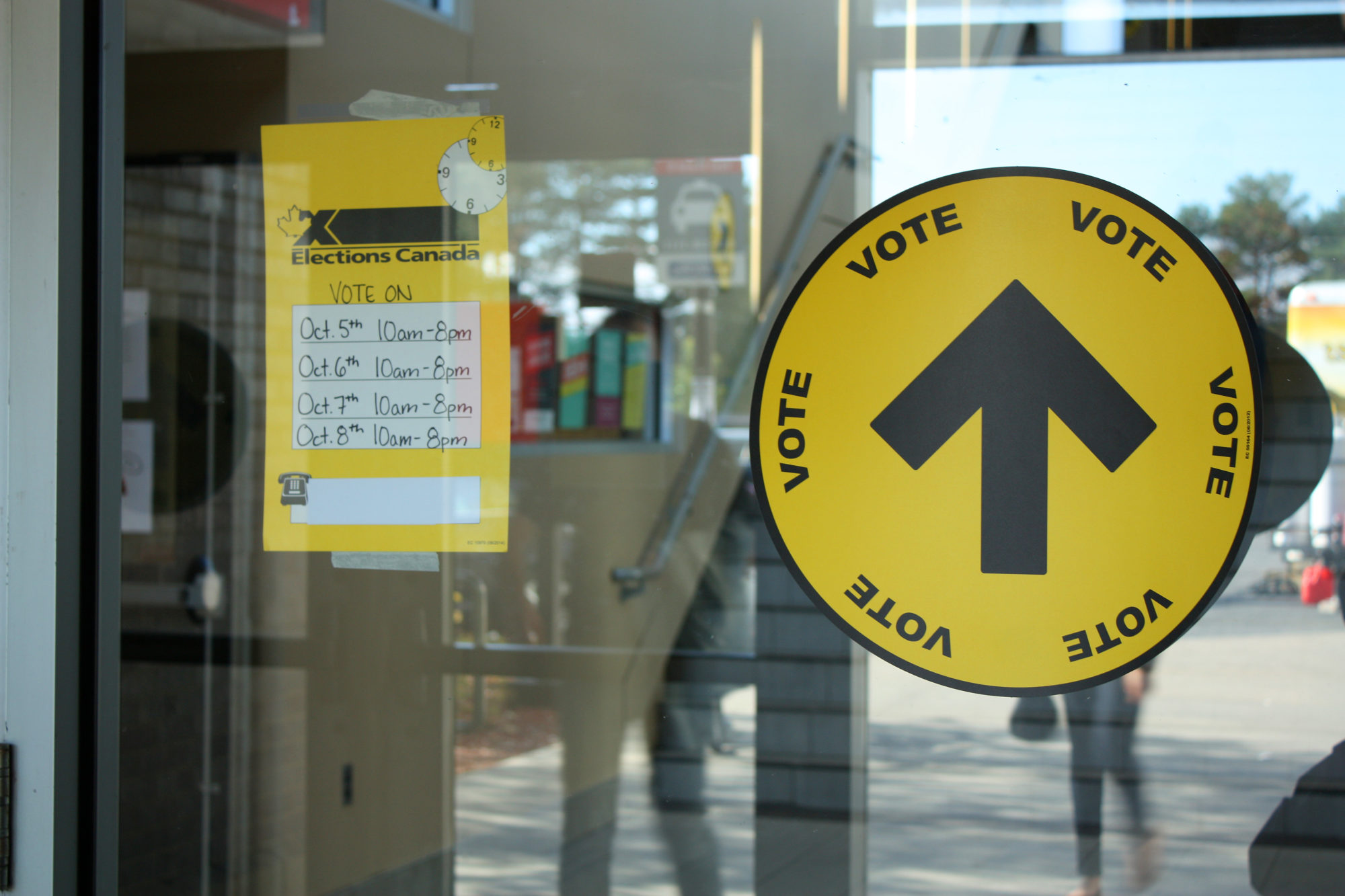 Election signs on a door heading into a polling booth
