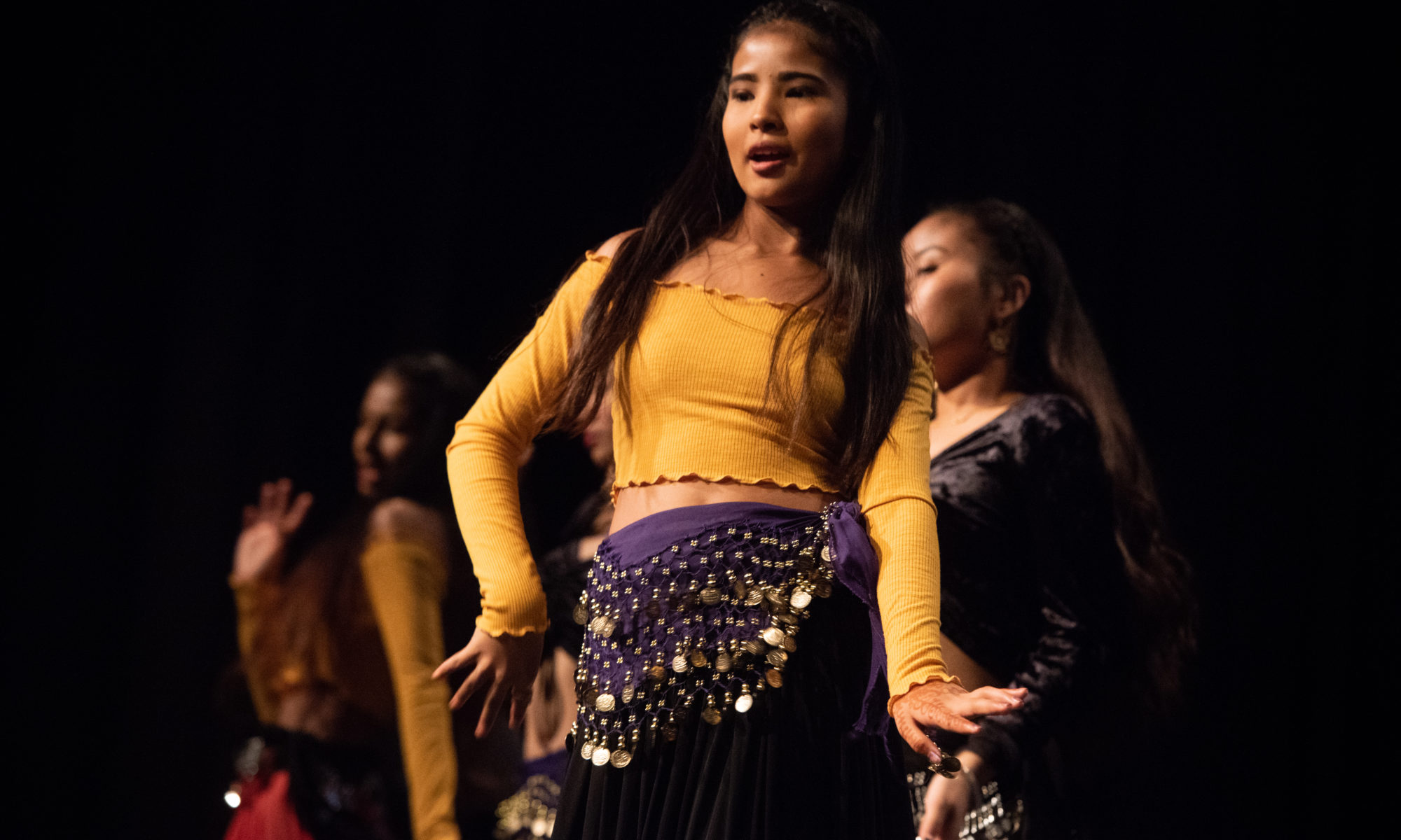 Dancers in yellow and purple ethnic costumes at Diwali festival in Halifax