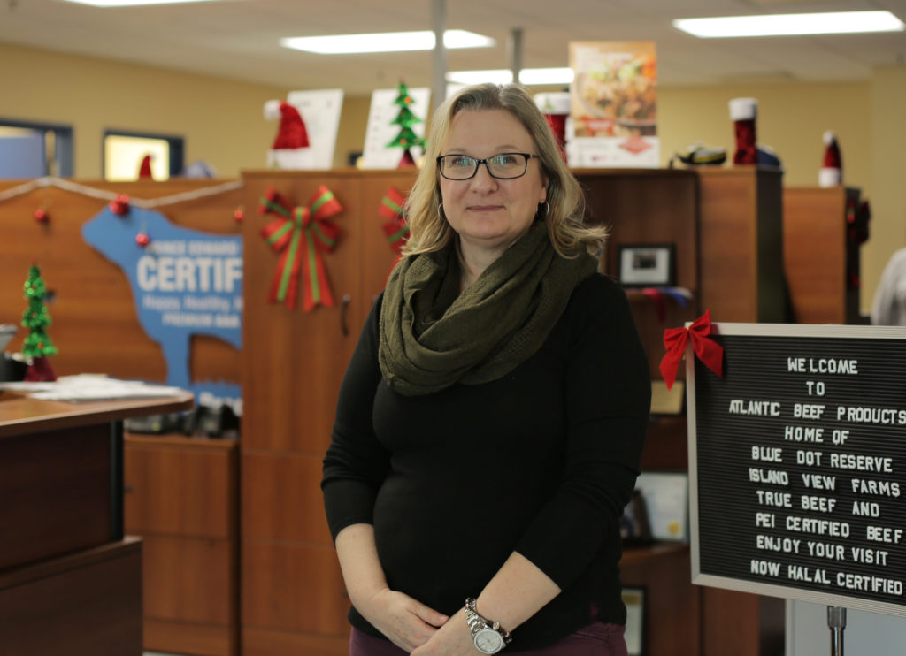 Diane Thibeault is head of human resources Atlantic Beef Products stands in the company's offices near a sign that reads in part Now Halal Certified.