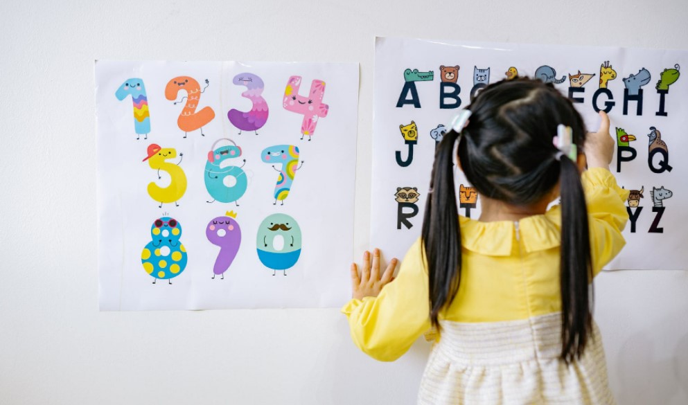 girl reading the alphabet