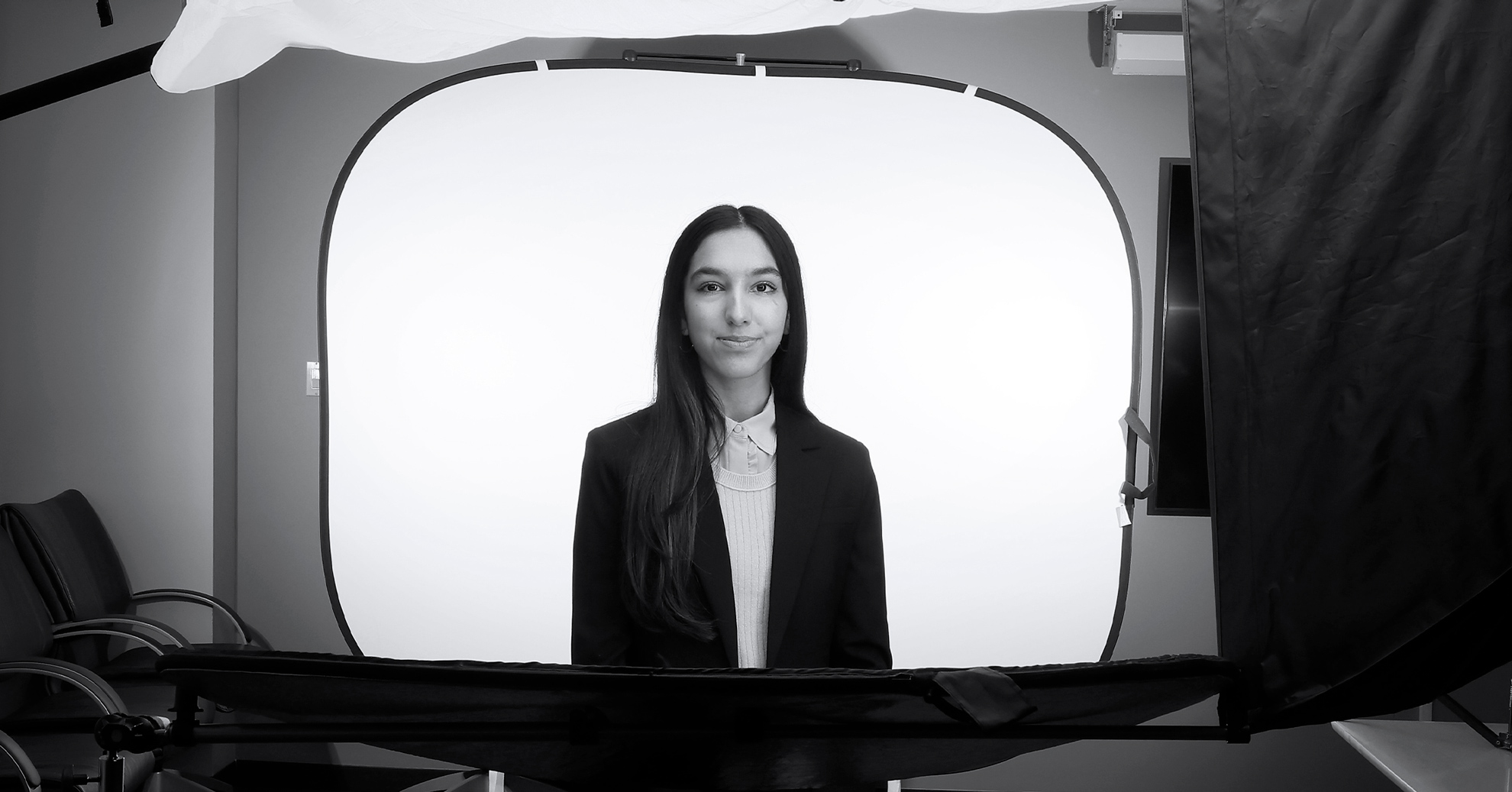 Naila Moloo stands in front of photography equipment