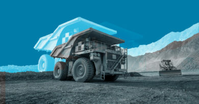 A mining truck is seen against large mountains
