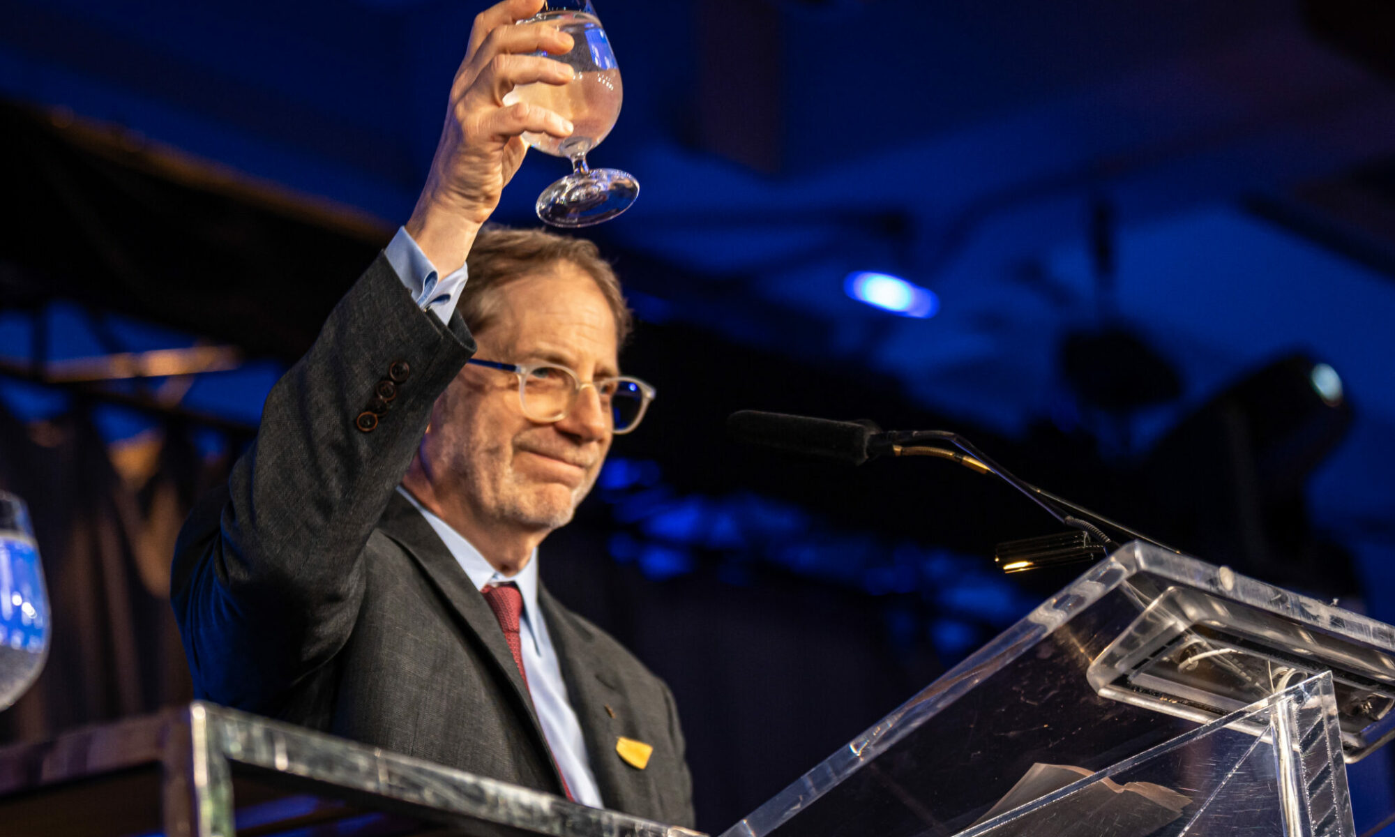 Edward Greenspon holds up a glass for toast after his speech