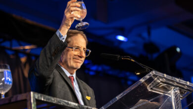 Edward Greenspon holds up a glass for toast after his speech